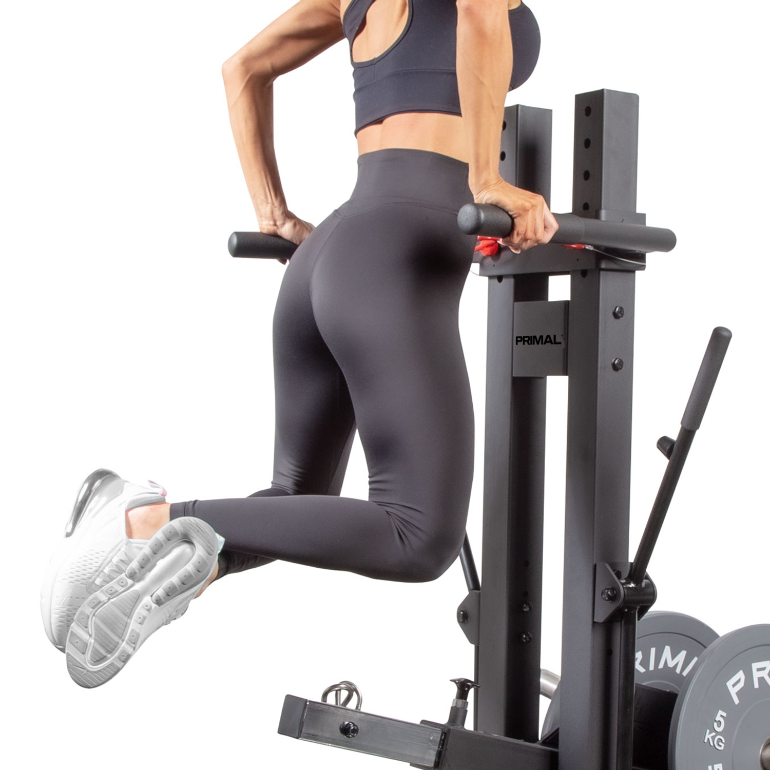 An athlete performing dips on a plate loaded belt squat machine.