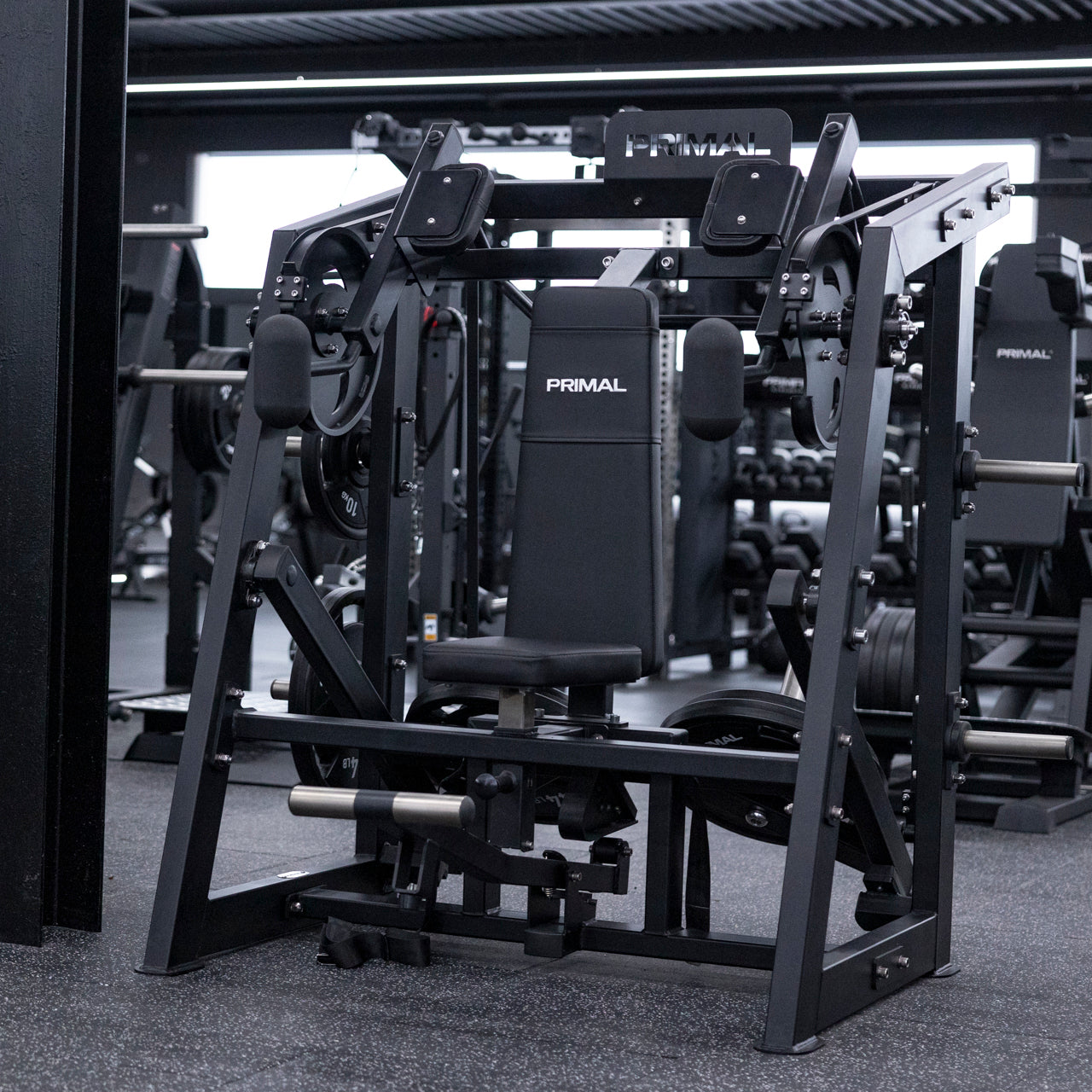 Angled view of plate-loaded pullover machine in gym setting.