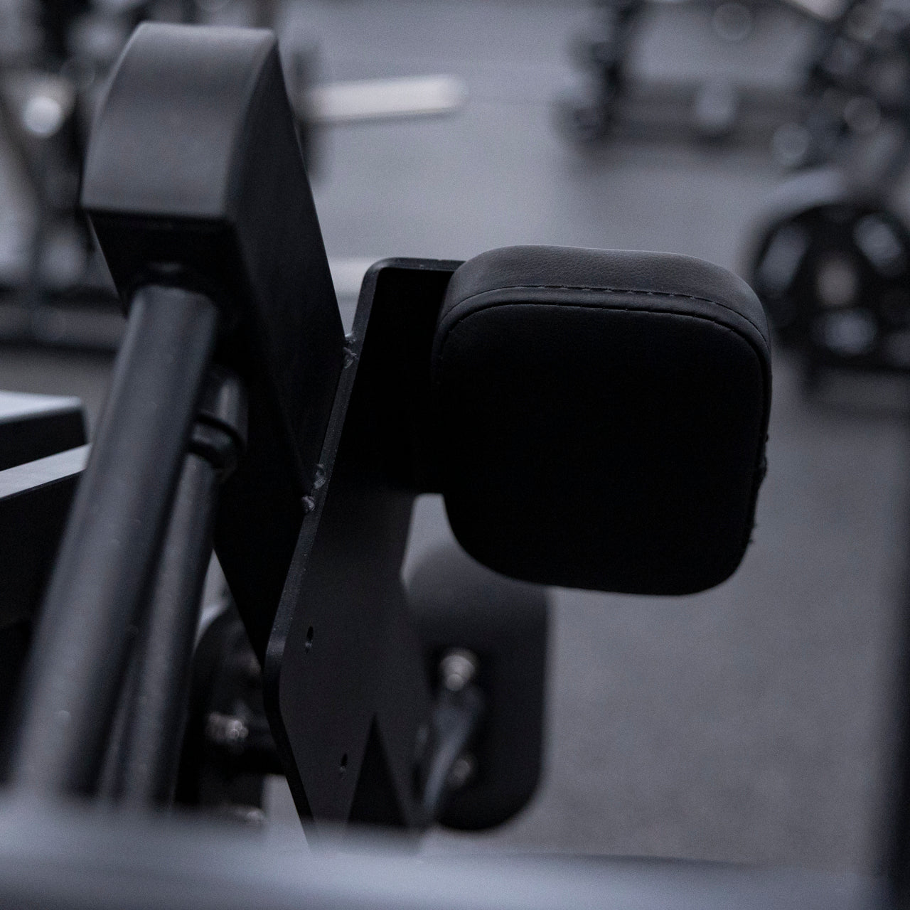 Close view of arm pads used on plate-loaded pullover machine.