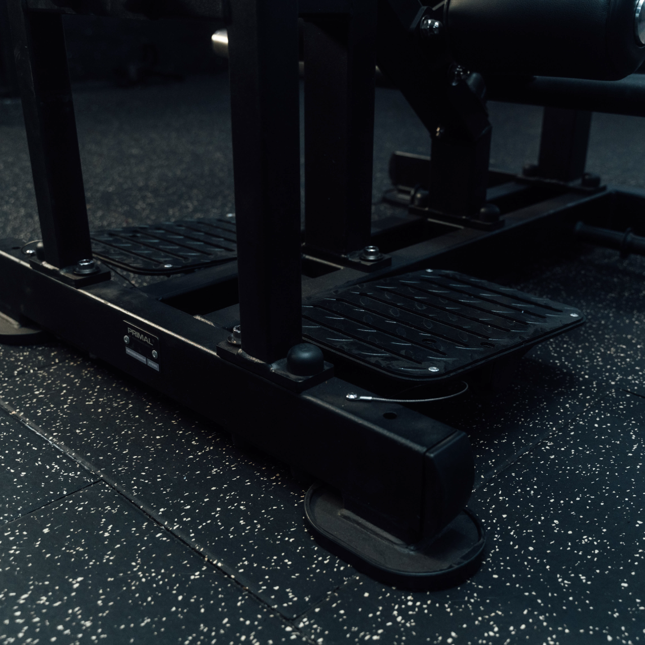 Close up view of steel footplate on standing hip thrust machine.