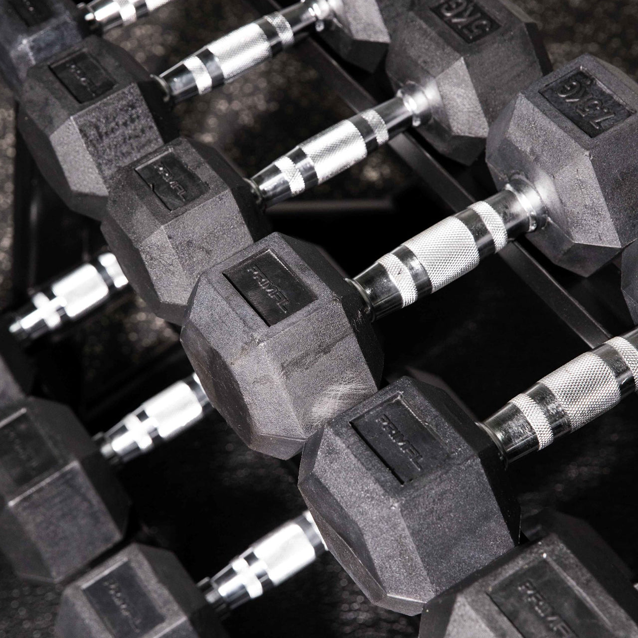 A close up of hex dumbbells with steel handles.