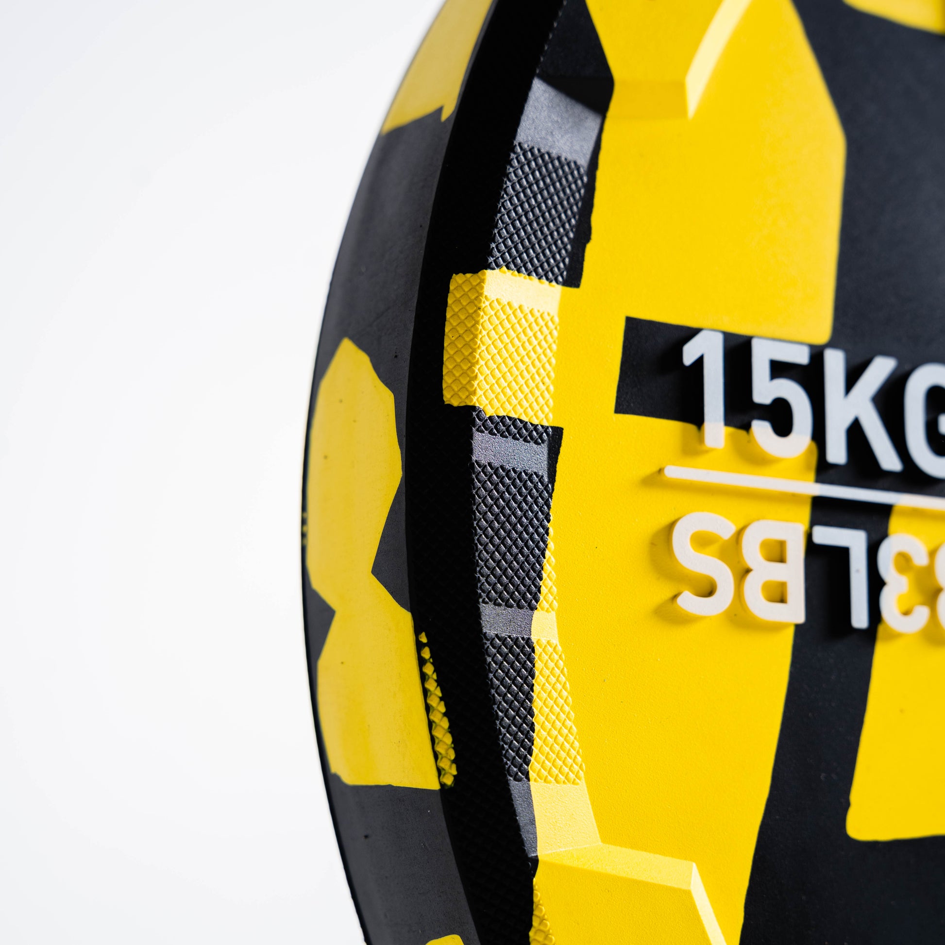Yellow and black weightlifting plate with '15kg' and '33lbs' text on a white background