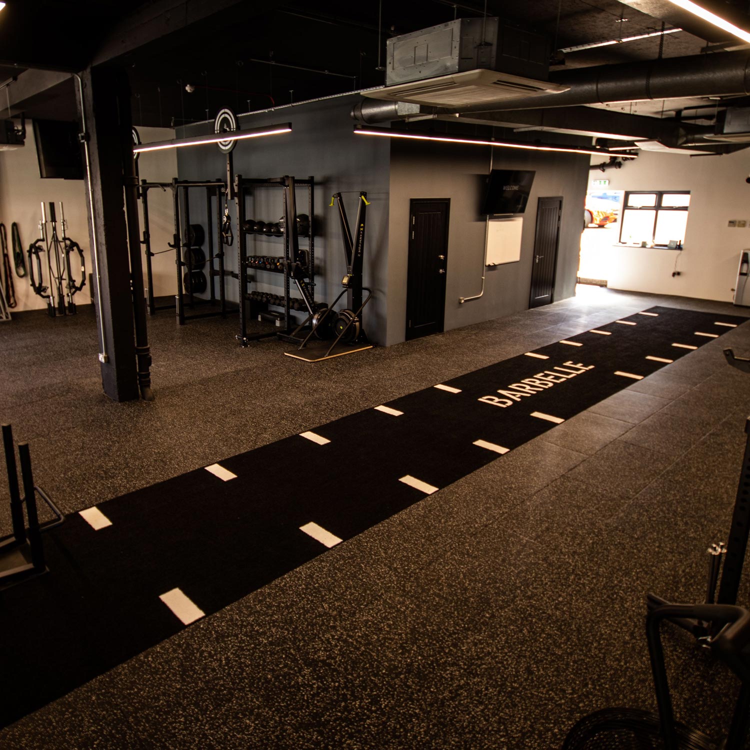 a custom barbelle black and white astro turf gym track