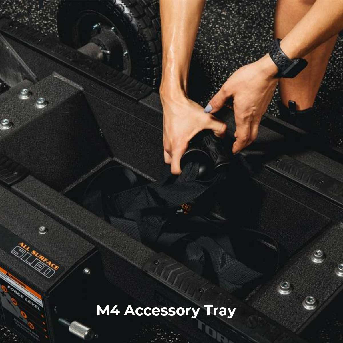a woman adding d handles to the toque m4 prowler sleds accessory tray