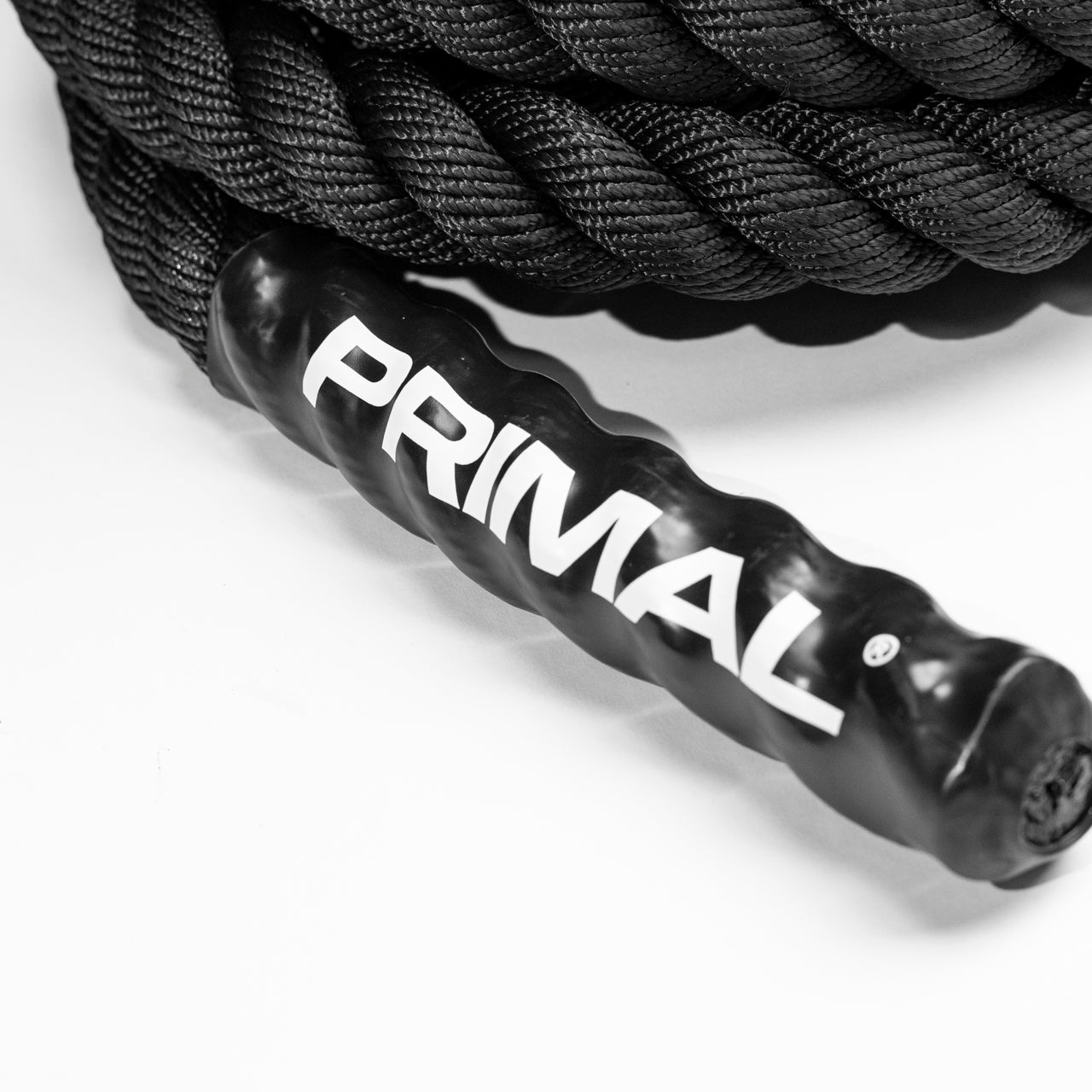 A close up of the handle of a sled pull rope with white branding printed on it.