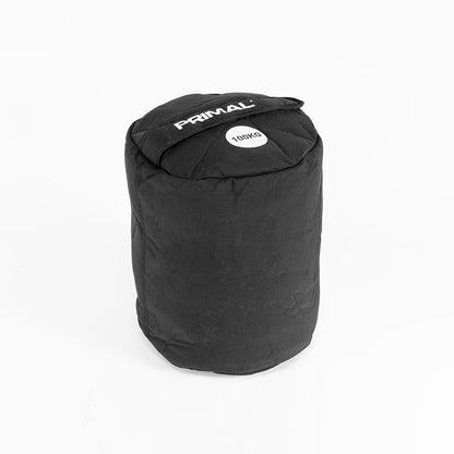 A 100kg black sandbag with handle for strongman workouts.