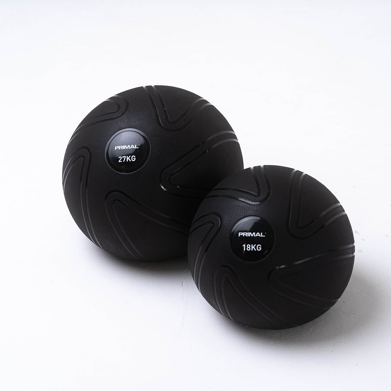 A 18kg and 27kg anti burst black slam ball.