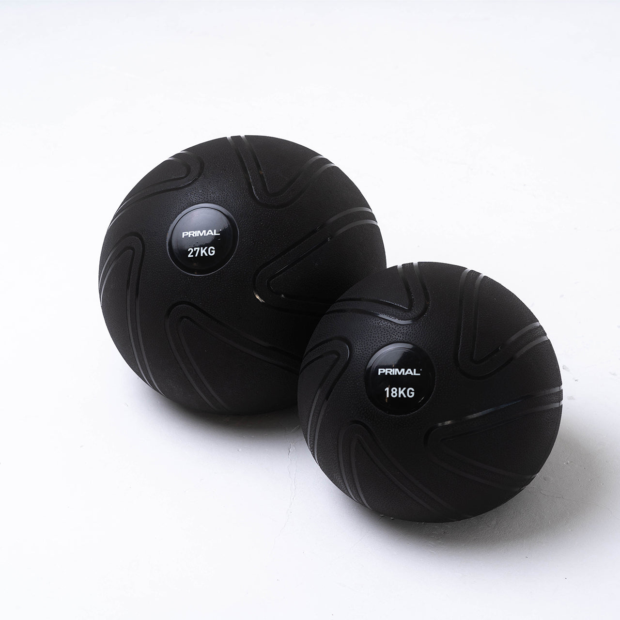 A 18kg and 27kg anti burst black slam ball.
