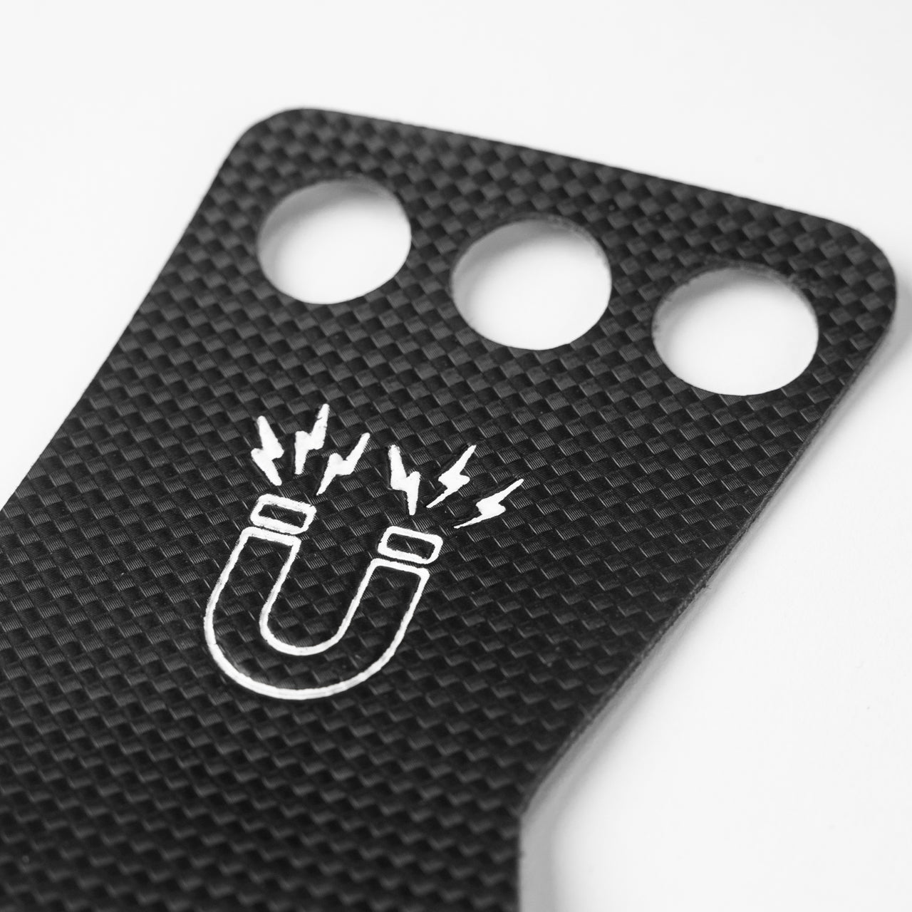 A close up of the three grip holes on a black gymnastic grip.