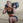 Woman performing a lunge movement with a sandbag in a gym.