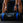 Person holding a 20kg Primal sand bag in a gym setting.