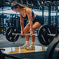 Woman lifting a barbell with weights in a gym setting