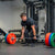 An athlete performing a deadlift using a loaded deadlift barbell.