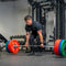 An athlete performing a deadlift using a loaded deadlift barbell.