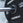 Close up view of a magnetic lockjaw collar securing a bumper plate in place on a barbell.