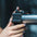 Close up view of athlete sliding a magnetic lockjaw collar onto a barbell.