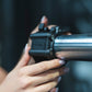 Close up view of athlete sliding a magnetic lockjaw collar onto a barbell.