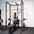 An athlete using the lat pulldown attachment on a home gym rack.