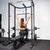 An athlete using the lat pulldown attachment on a home gym rack.
