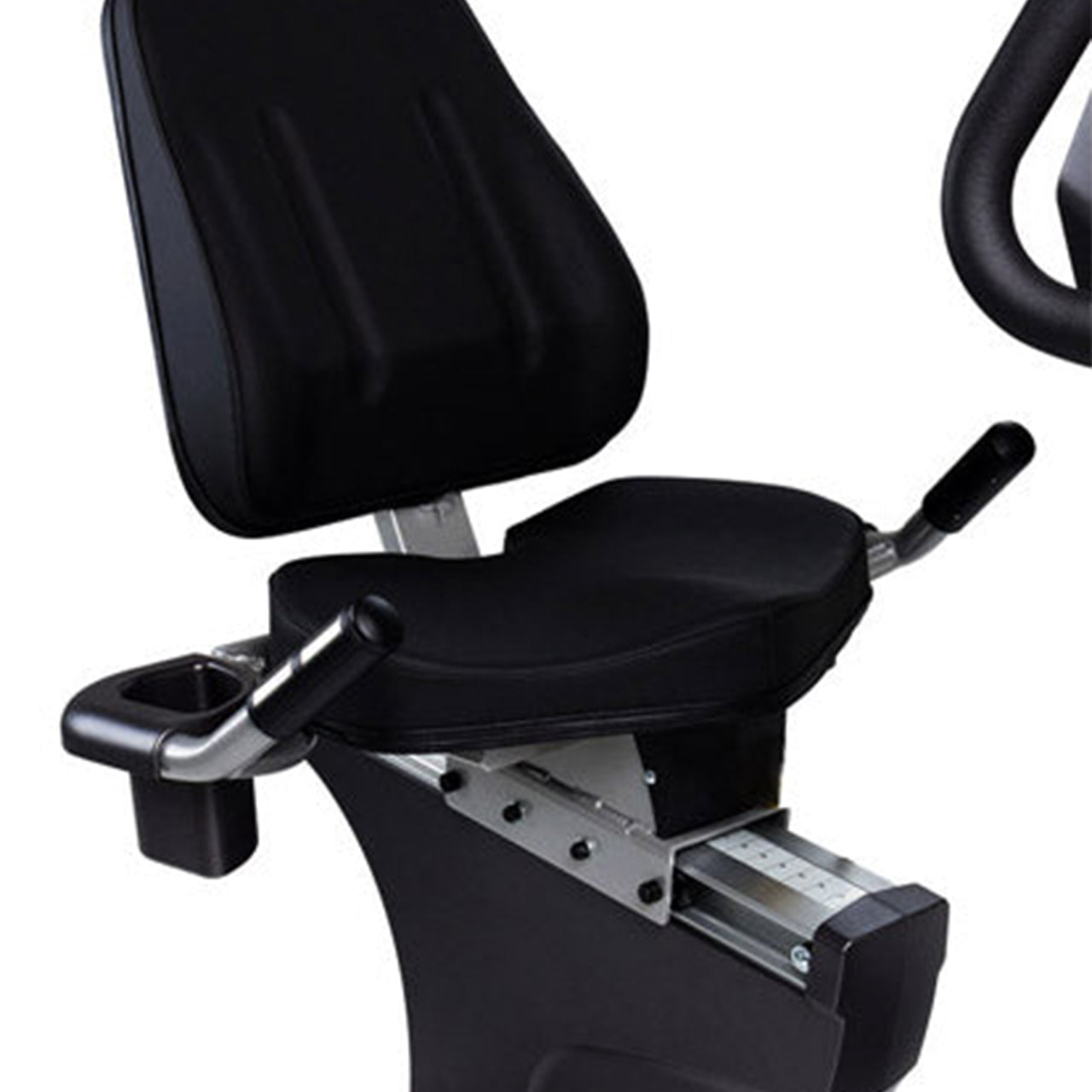 A close up of an indoor recumbent exercise bike.