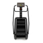 Black exercise stepper with digital display on a white background.