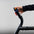 An athlete adjusting the resistance level on an exercise stepper machine.