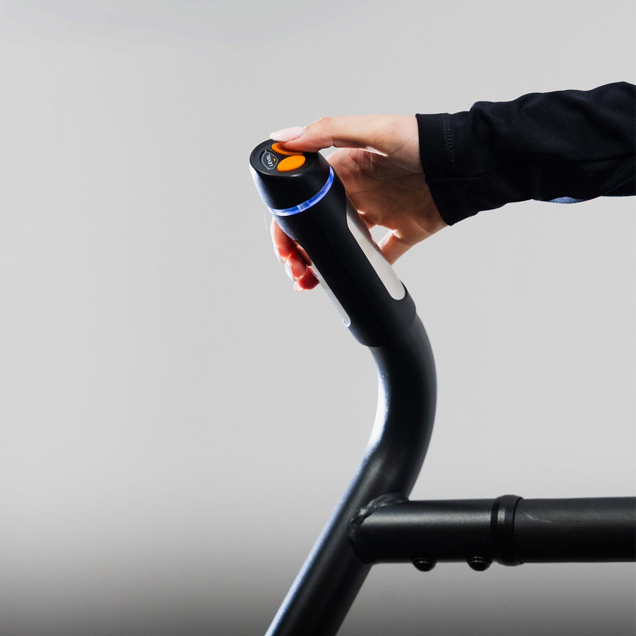 An athlete adjusting the resistance level on an exercise stepper machine.