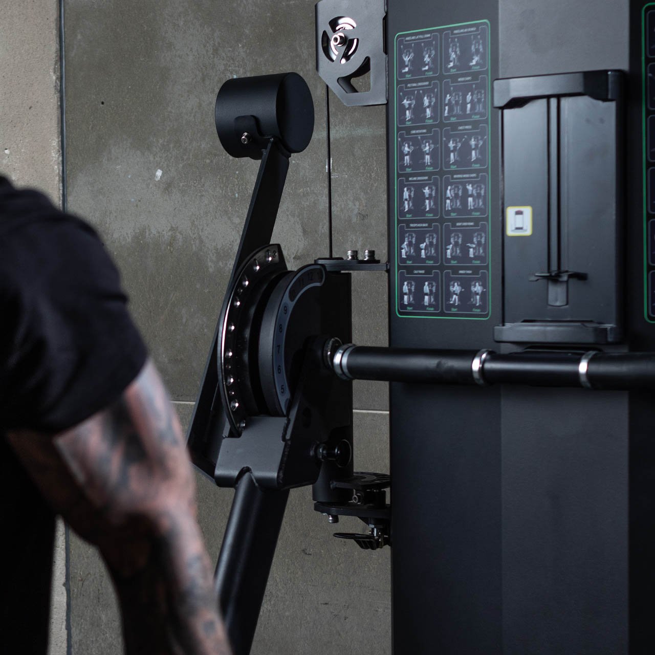 A close up of the cable pulley system on a dual arm functional trainer machine.