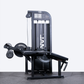 Black leg extension and prone leg curl machine with Primal logo in a gym.