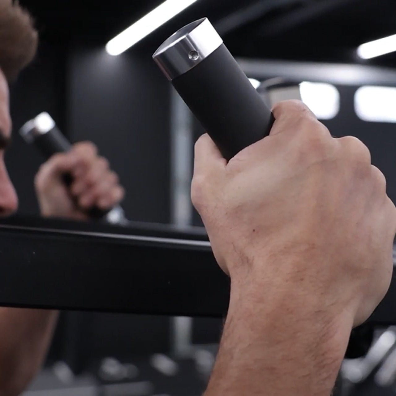 A close up of a grip handle on a standing calf raise & viking press machine.
