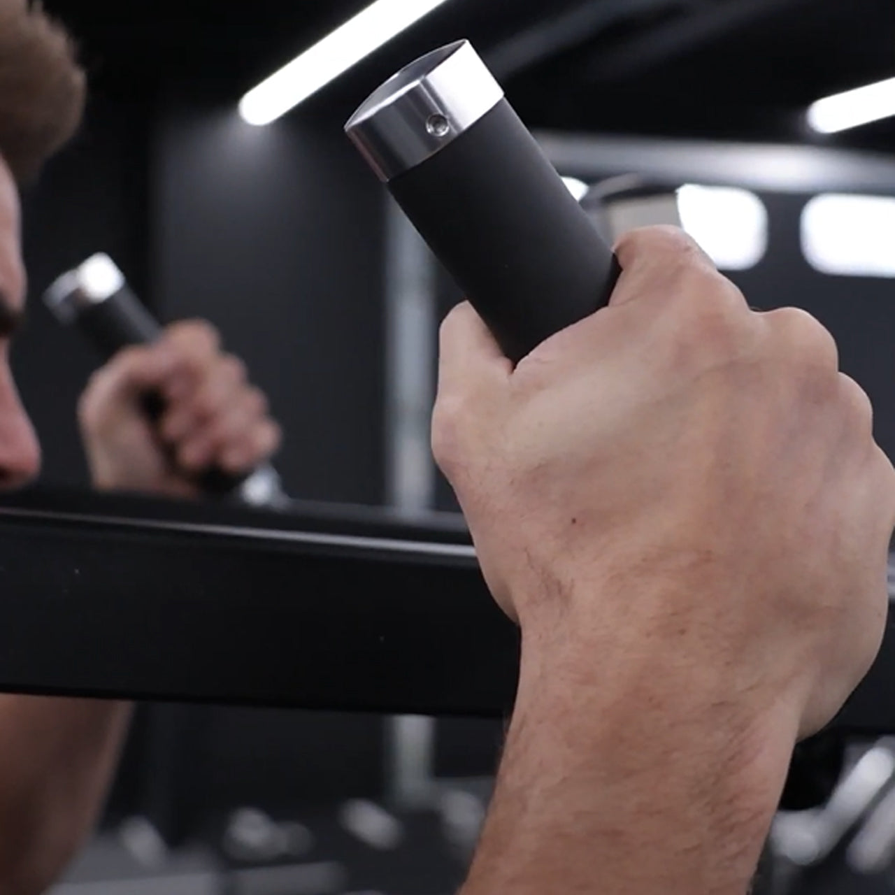 A close up of a grip handle on a standing calf raise & viking press machine.