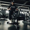 An athlete using a seated calf raise machine loaded with weight discs.