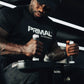 An athlete holding the handles on a seated calf raise machine.