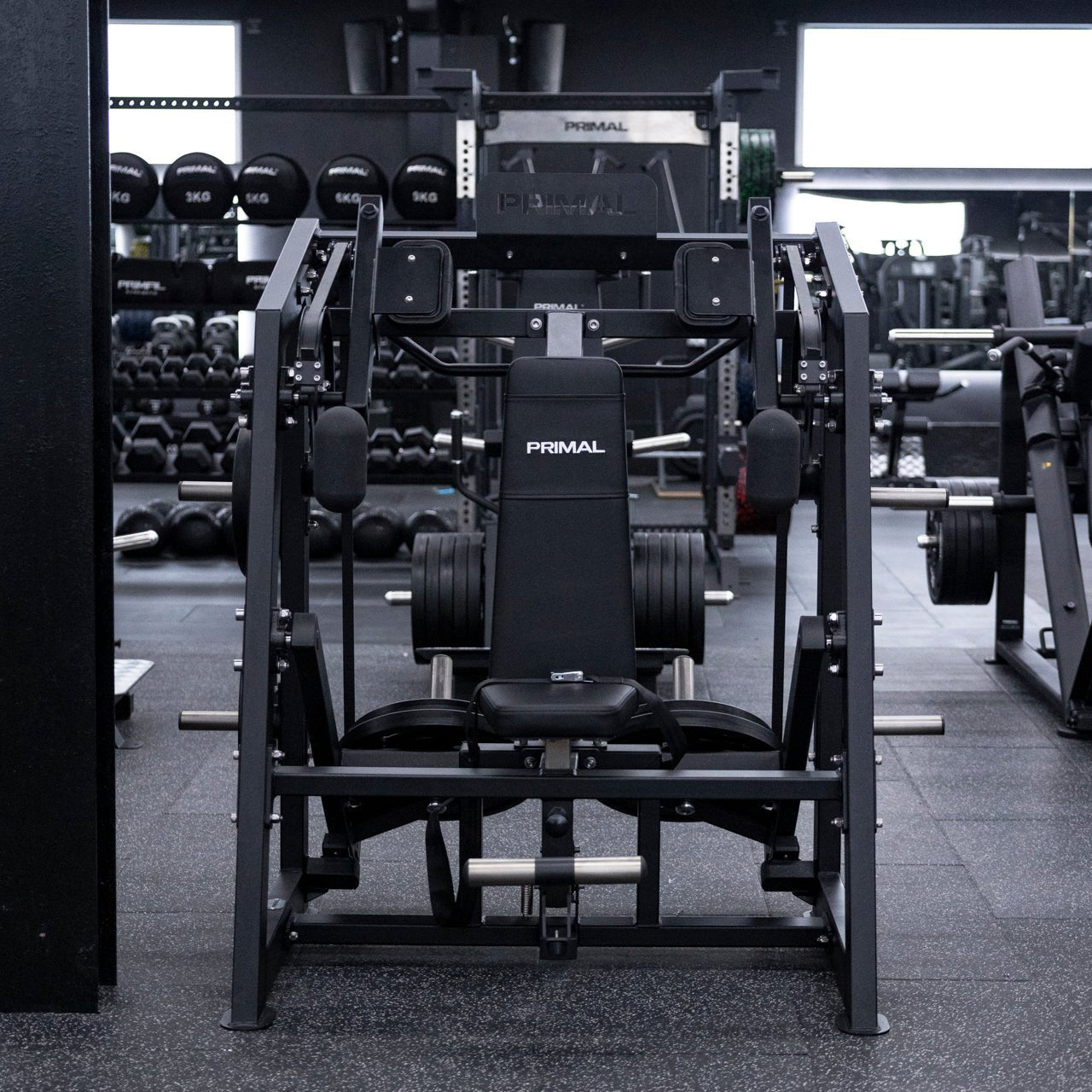 Straight on view of plate-loaded pullover machine in gym.