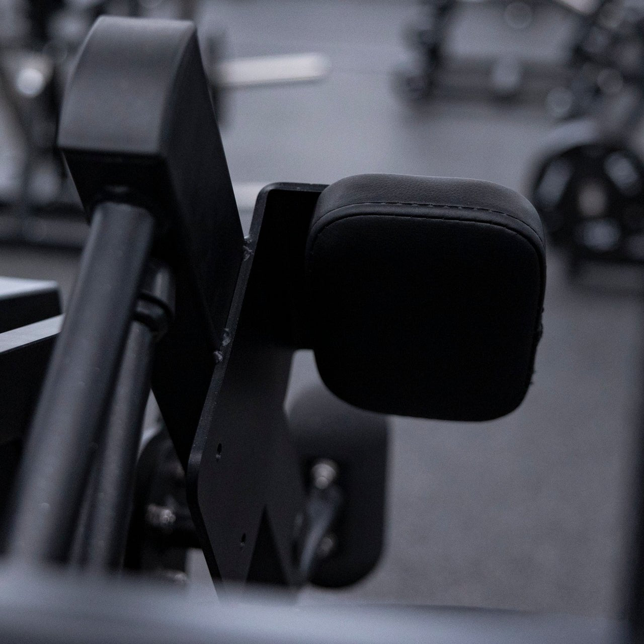 Close view of arm pads used on plate-loaded pullover machine.