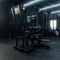 Angled view of plate-loaded standing hip thrust machine in gym.
