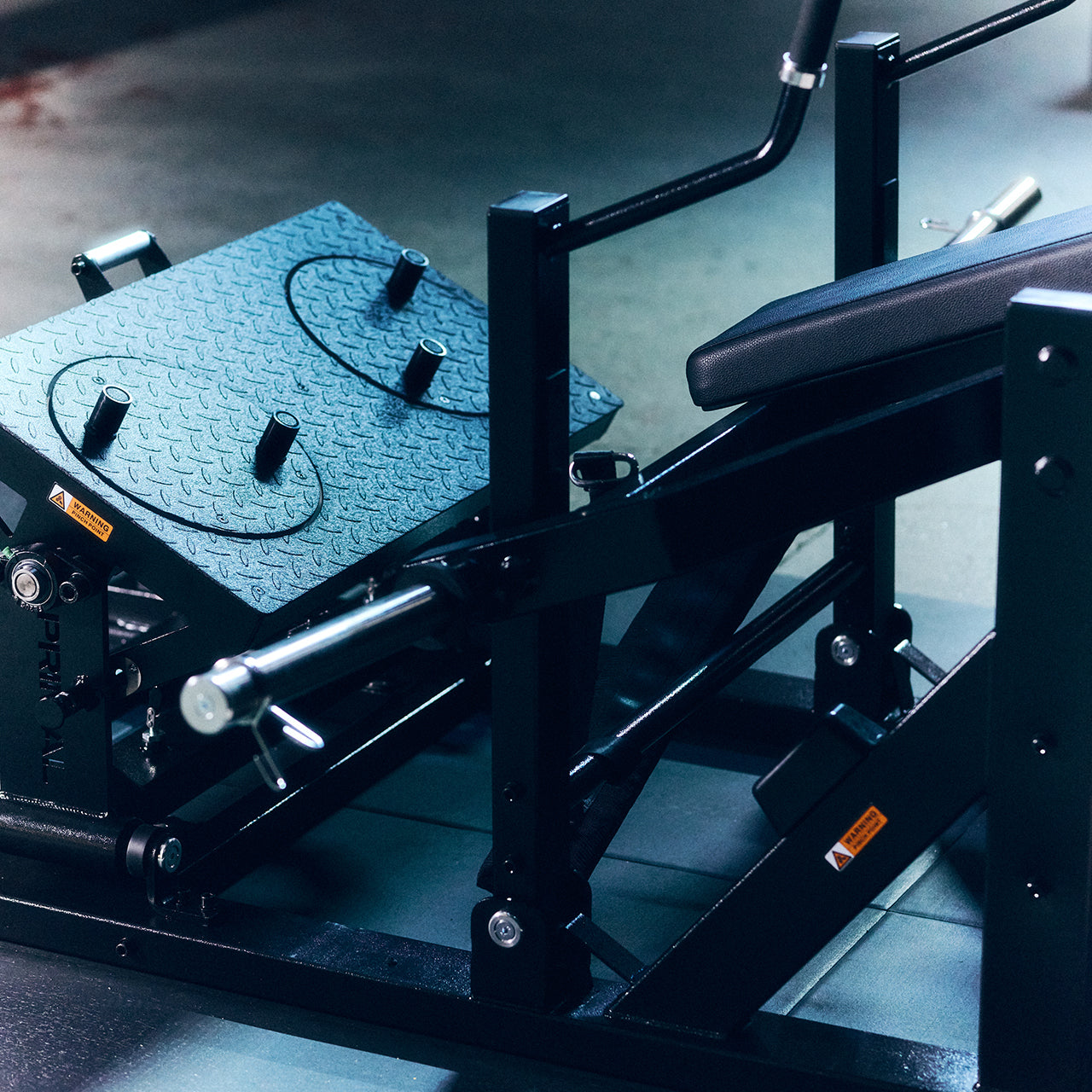 A close up of a footplate on a glute drive machine in a gym.