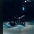 Dark and moody scene with a glute drive machine in a dimly lit room.