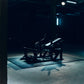 Dark and moody scene with a glute drive machine in a dimly lit room.