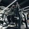 An athlete pre-stretching on a plate loaded ab crunch machine.
