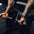 Close-up of an athlete's hands gripping the handles on a bicep curl machine.