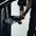 Person adjusting the seat height on a bicep curl machine. 