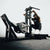 An athlete using a plate loaded belt squat machine in a gym.