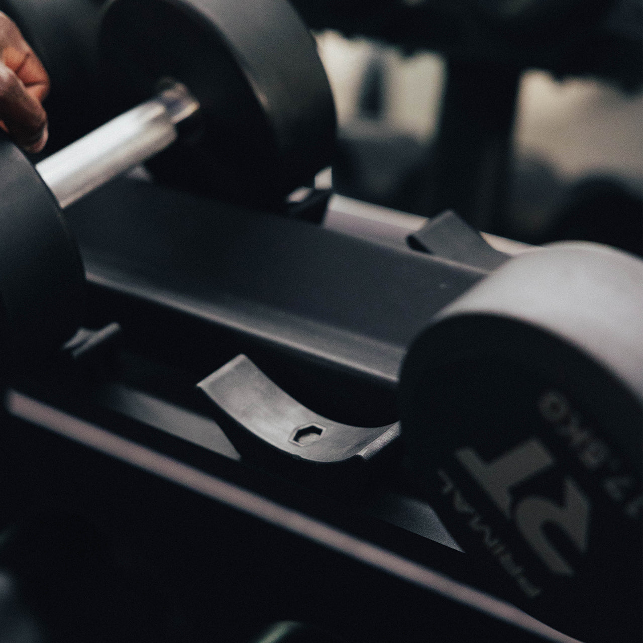 A saddle on a horizontal dumbbell storage rack.