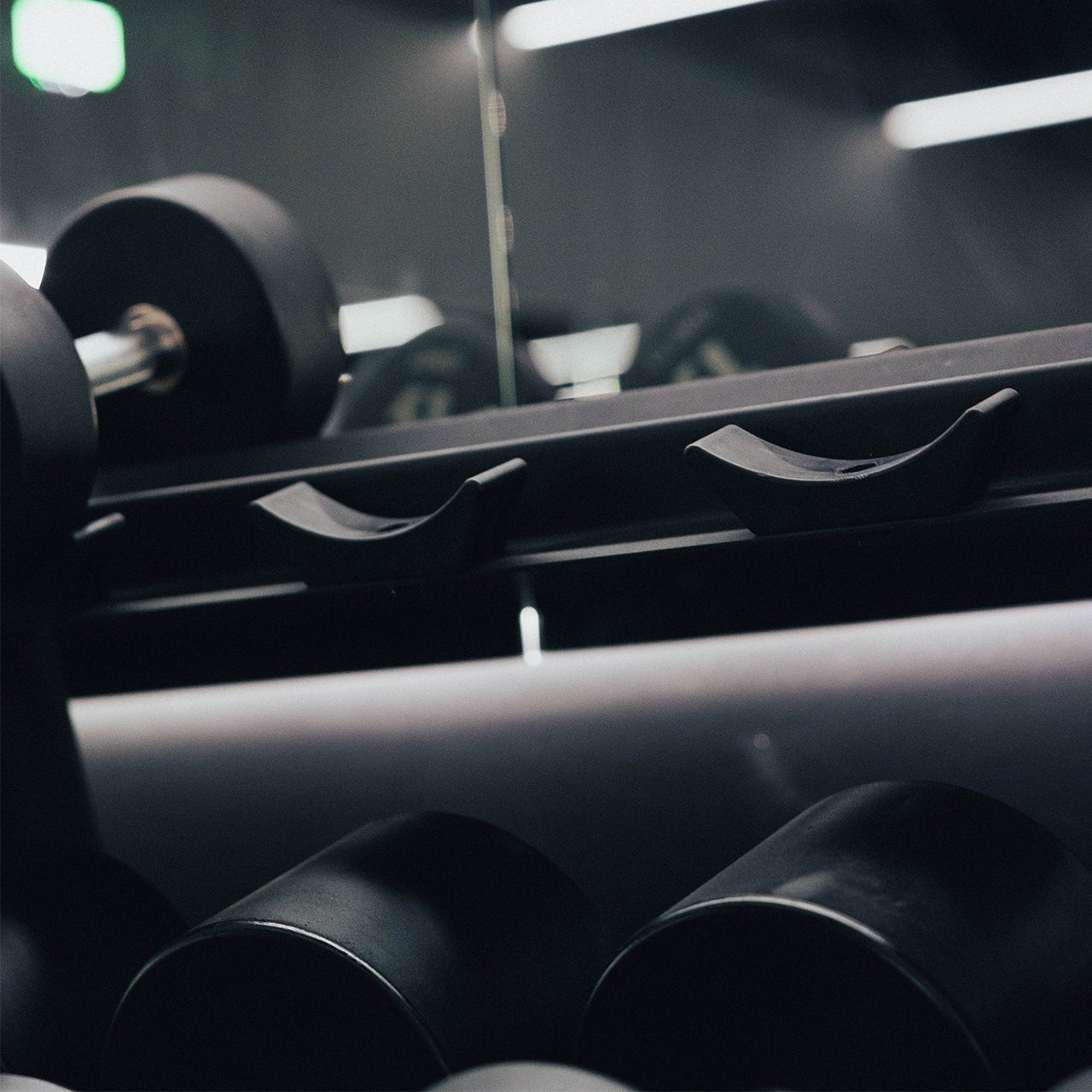 Saddles on a horizontal dumbbell storage rack.