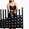 An athlete storing urethane studio dumbbells on a storage rack.