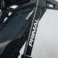 Close-up of a folding treadmill frame with 'Primal' branding on a light gray background