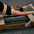 Person using a Pilates reformer machine in a gym setting.