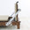 Wooden pilates reformer with beige cushion on a white background