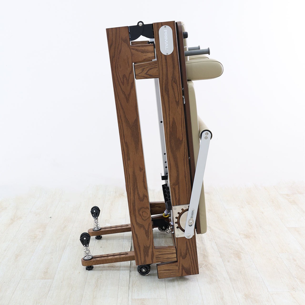 A folded pilates reformer machine on a white background.